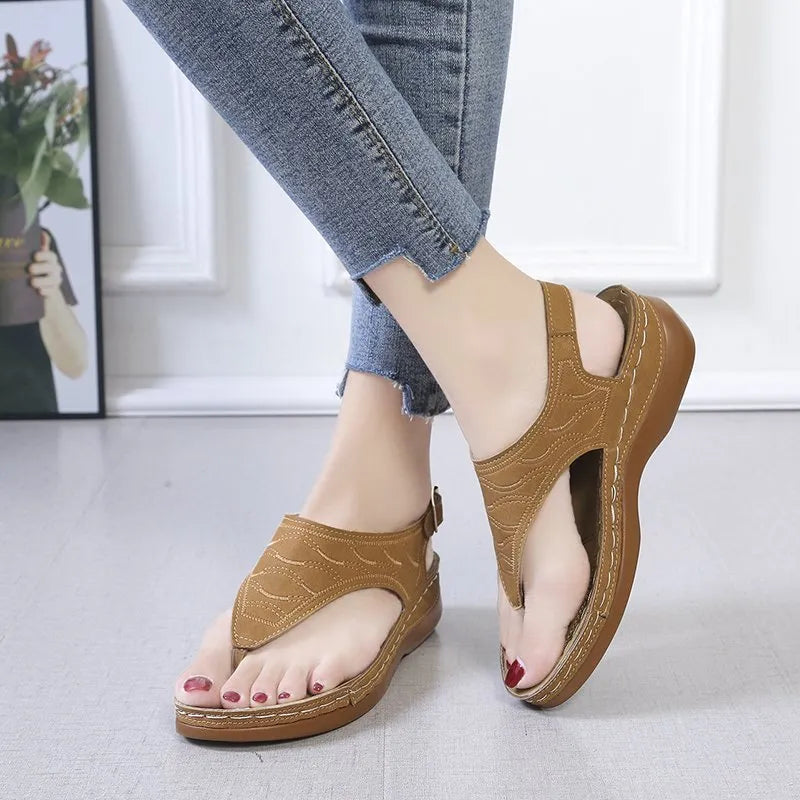 Women's wedge heel sandals with an adjustable buckle strap in a solid colour