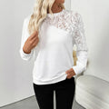 White floral pattern long sleeve pullover top with loose fit on hanger