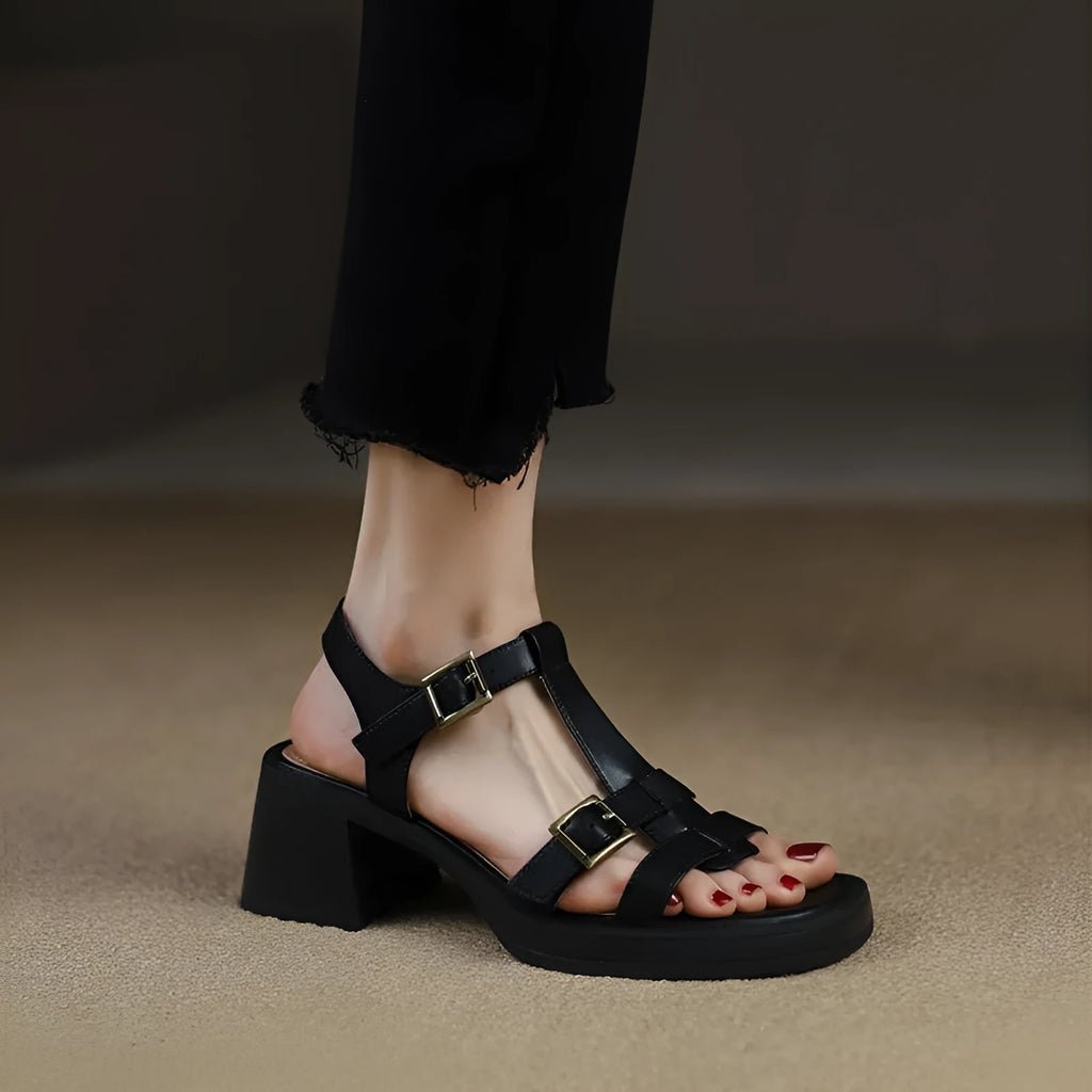 Women's black retro platform sandals with chunky heel and T-buckle strap on a white background.