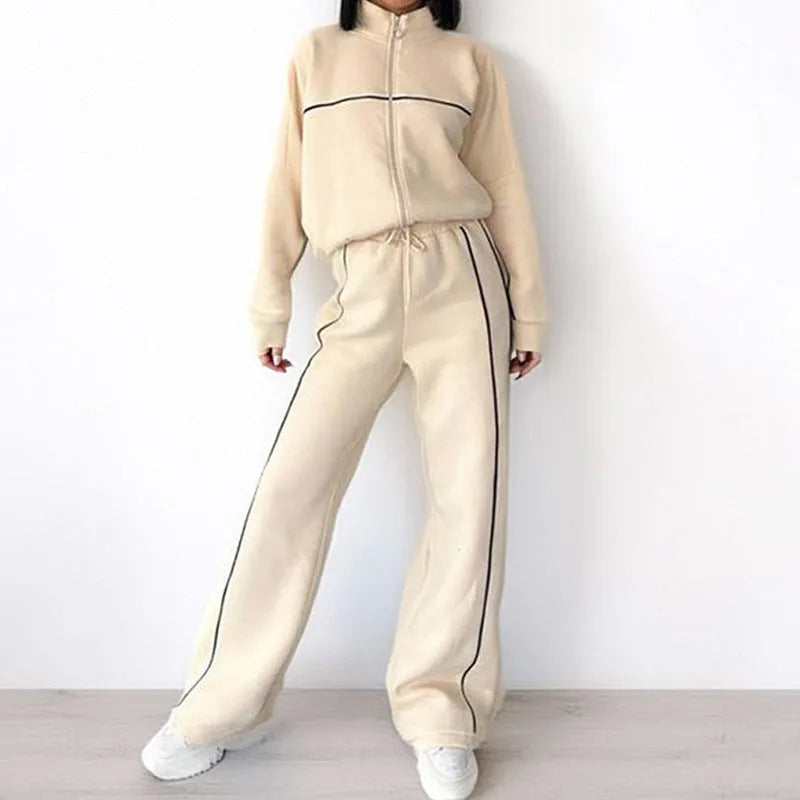 Casual striped suit set comprising a long sleeve mock neck hoodie and matching lace-up trousers.