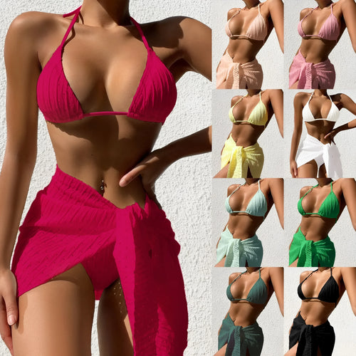 Women's three-piece halterneck bikini set with mesh skirt in a solid colour.