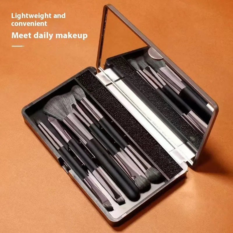 Portable makeup brush set with mirror showing silver or gold brushes with 2.6cm artificial fibre bristles