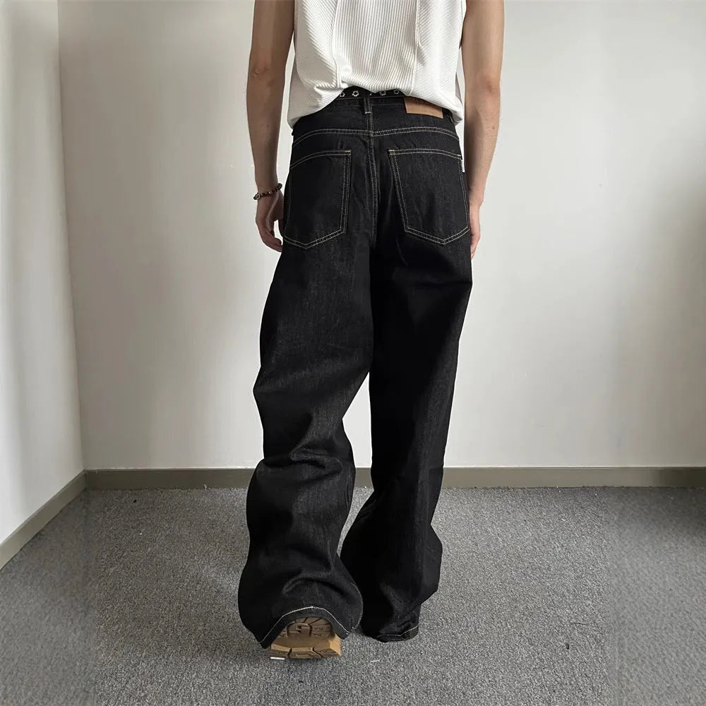 Man and woman modelling black retro wide-leg denim jeans with a straight loose fit.