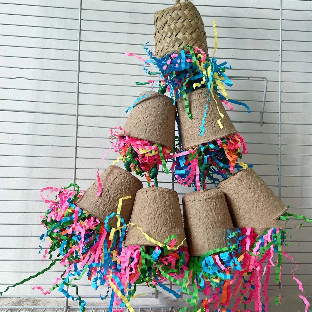 Wood-coloured woven palm fibre parrot chew toy shaped like a paper cup, hanging.