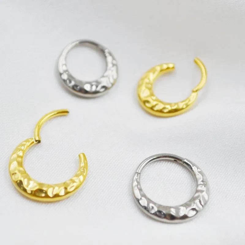 Close-up of a carved concave-convex titanium nose ring in silver finish