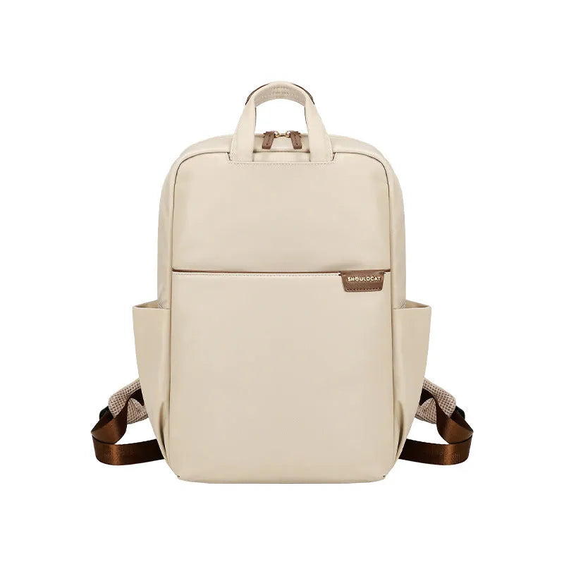 Simple canvas women's backpack in apricot colour showing internal organiser compartments and external pocket.