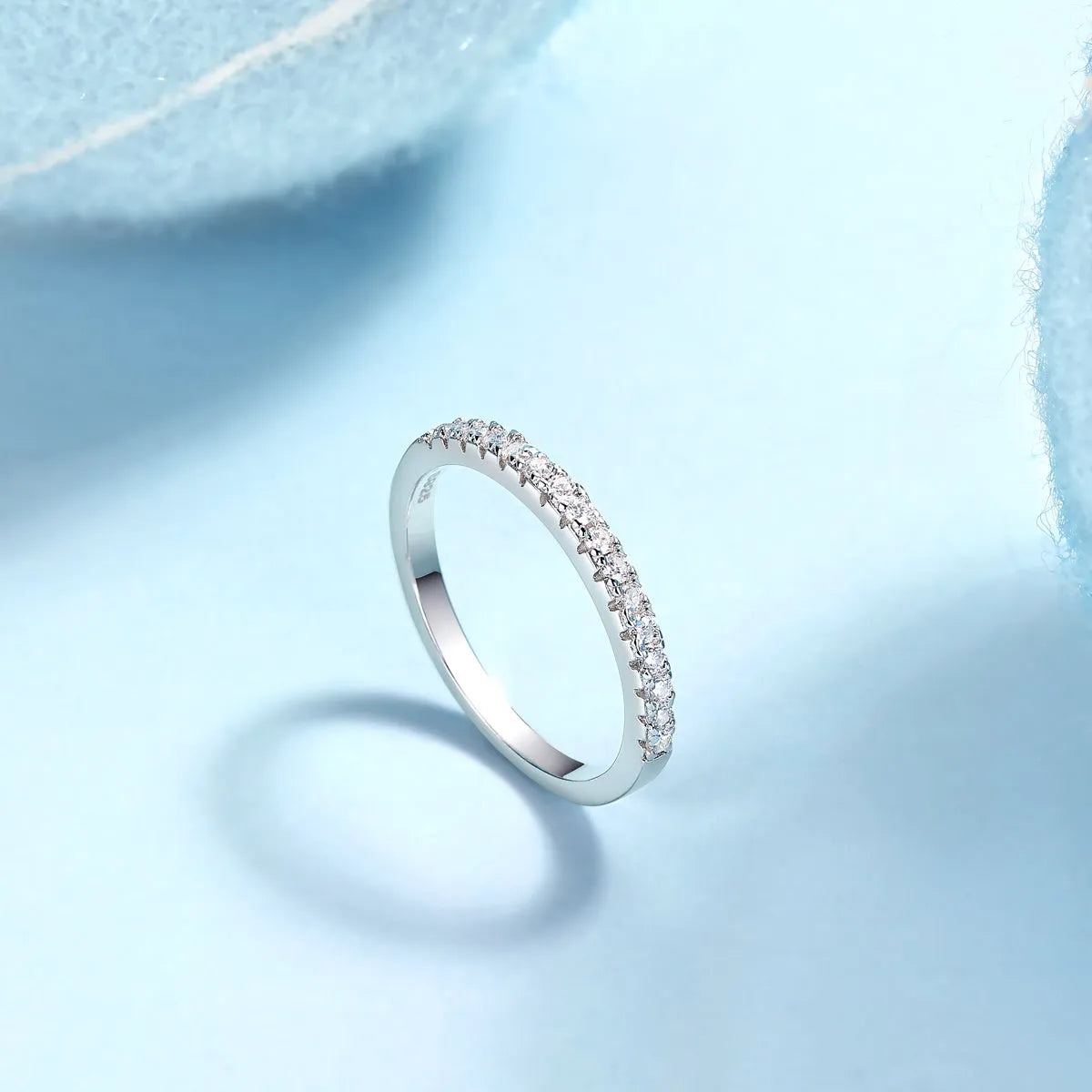 Parallel World moissanite wedding ring set in gold and rose gold on a gift box