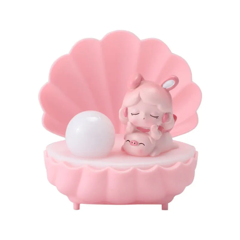 Resin cartoon small night lamp with pink pig girl design on a table