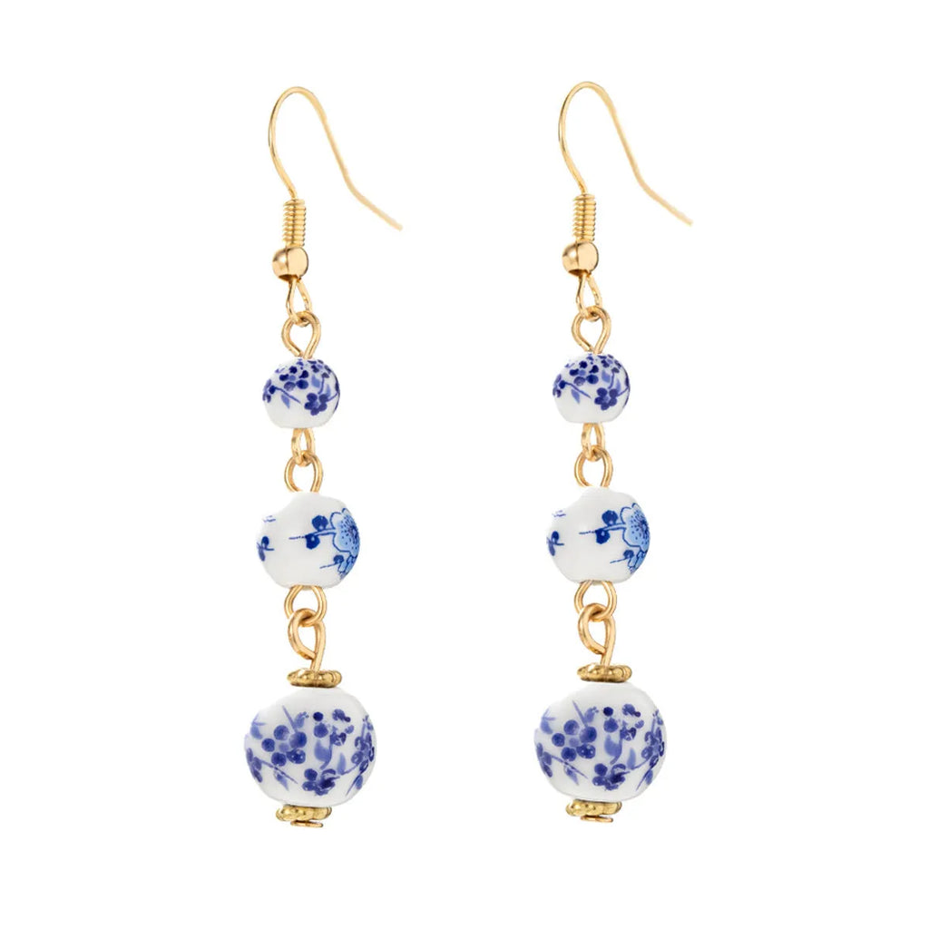 Long retro earrings with blue and white porcelain-coloured ceramic beads and geometric alloy details.