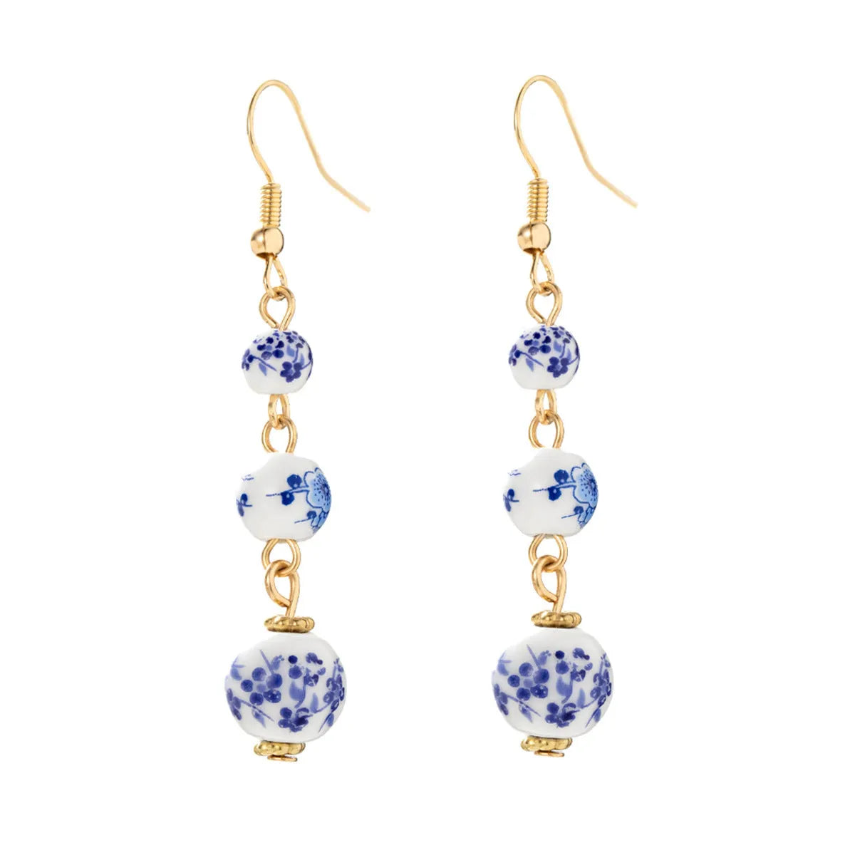 Long retro earrings with blue and white porcelain-coloured ceramic beads and geometric alloy details.