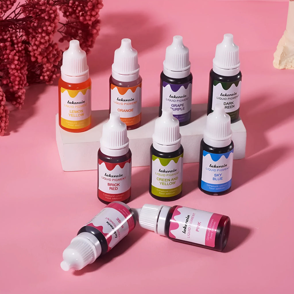 Set of 24 small food colouring bottles with assorted craft accessories including glitter, coins, and tools.