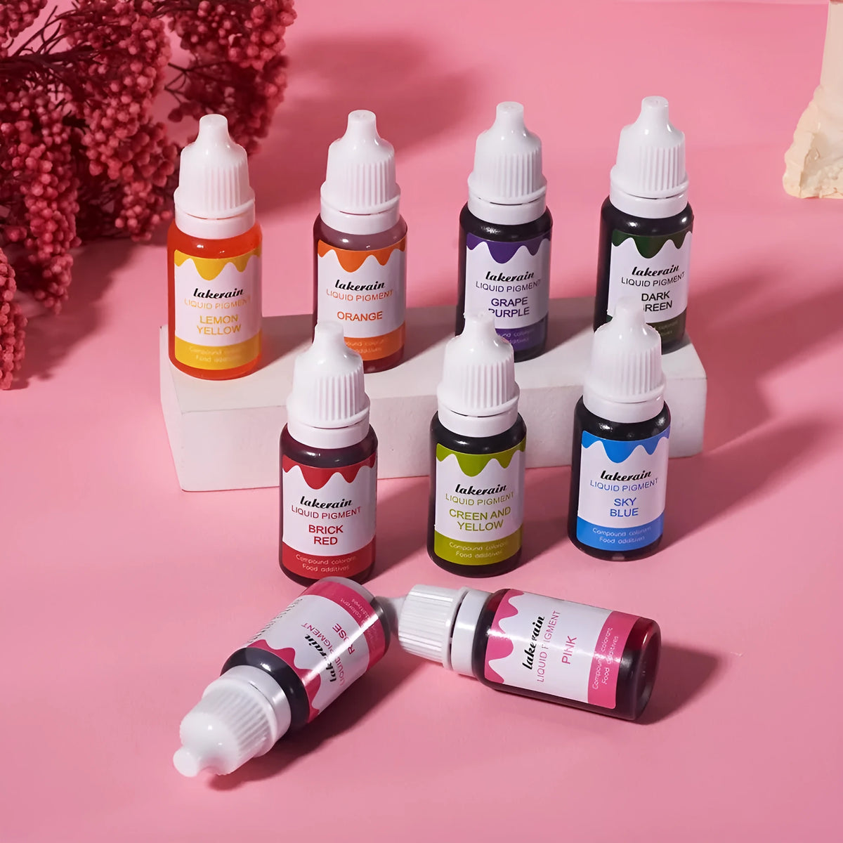 Set of 24 small food colouring bottles with assorted craft accessories including glitter, coins, and tools.