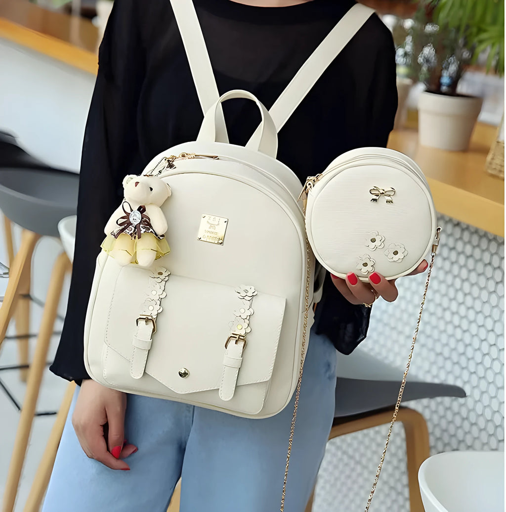 Women's three-piece PU leather bag set showing backpack, shoulder bag, and card holder with floral details