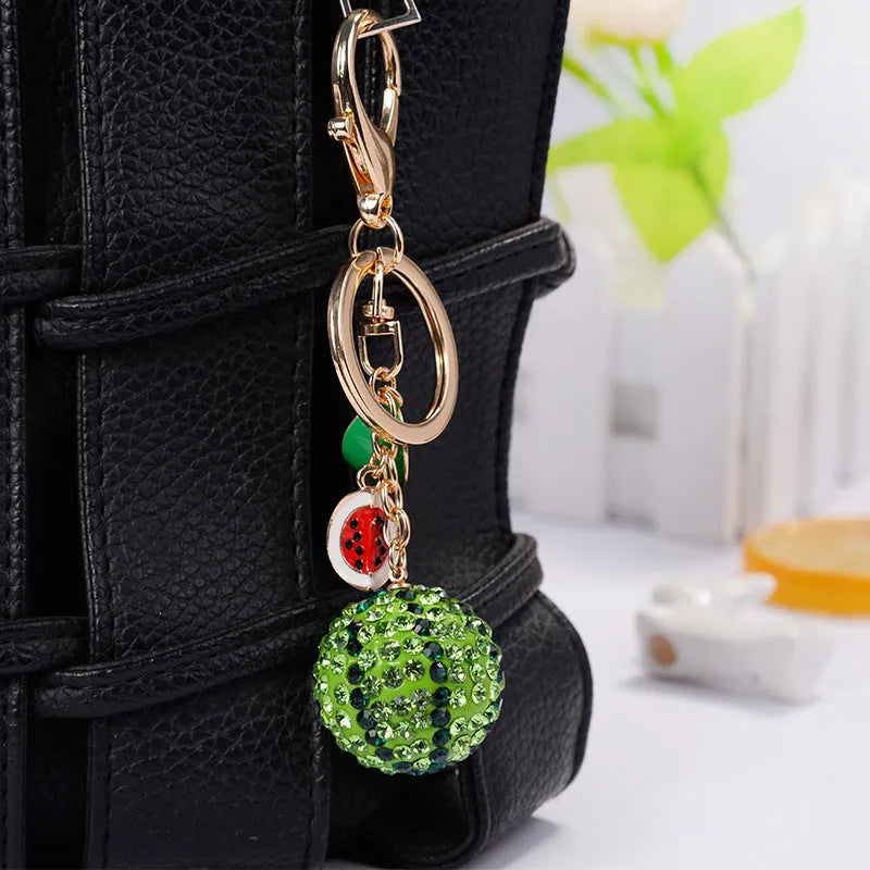 Green watermelon-shaped zinc alloy keychain measuring 12cm long