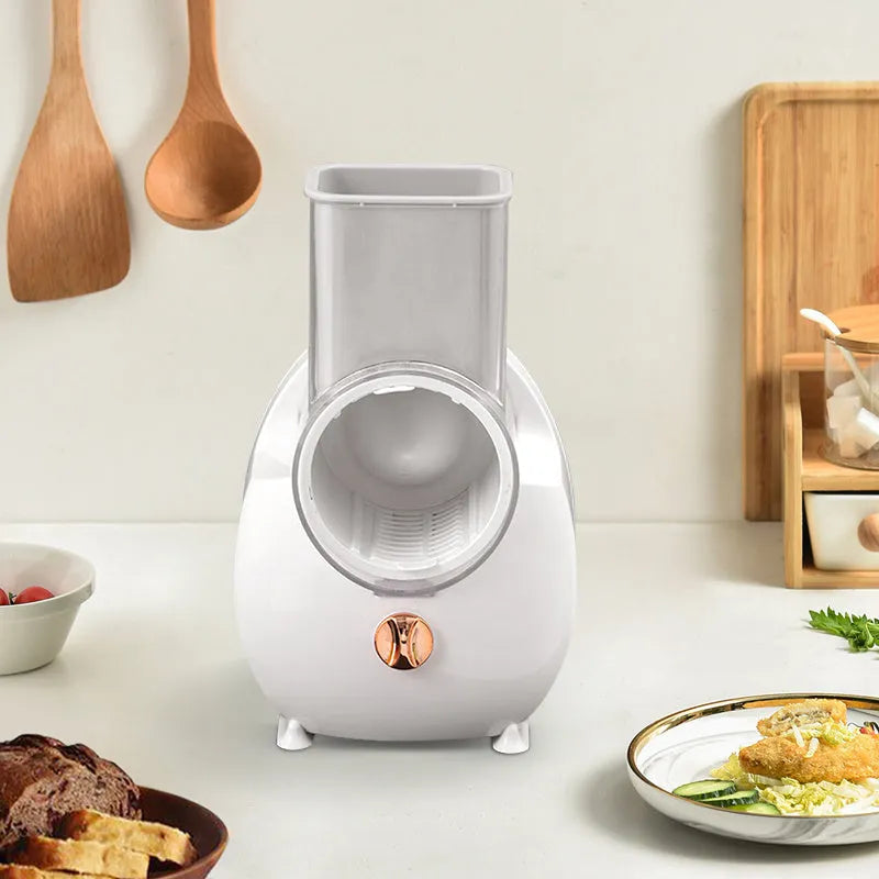 White electric vegetable slicer with suction base and multiple blades for potatoes and carrots
