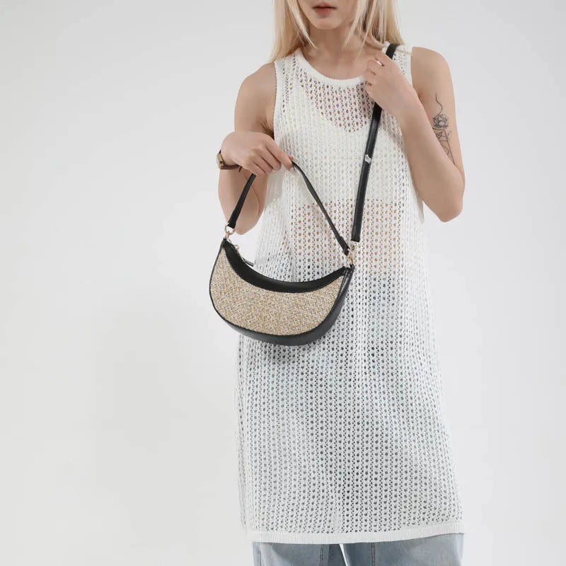 Women's straw crossbody dumpling bag in black colour with contrast stitching and organised internal compartments