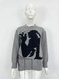 Grey and white women's alpaca wool sweater with tassel detail and abstract pattern.
