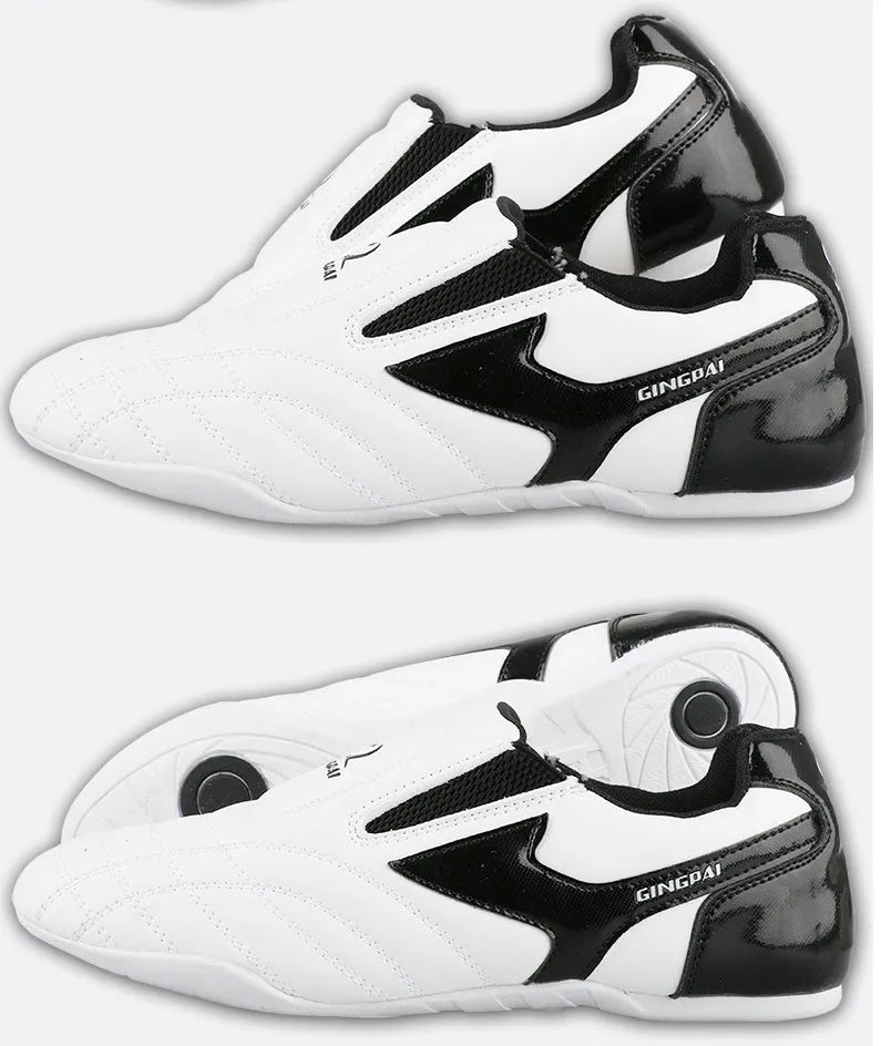 Black and white children's martial arts training shoes with soft bottom construction and widened design
