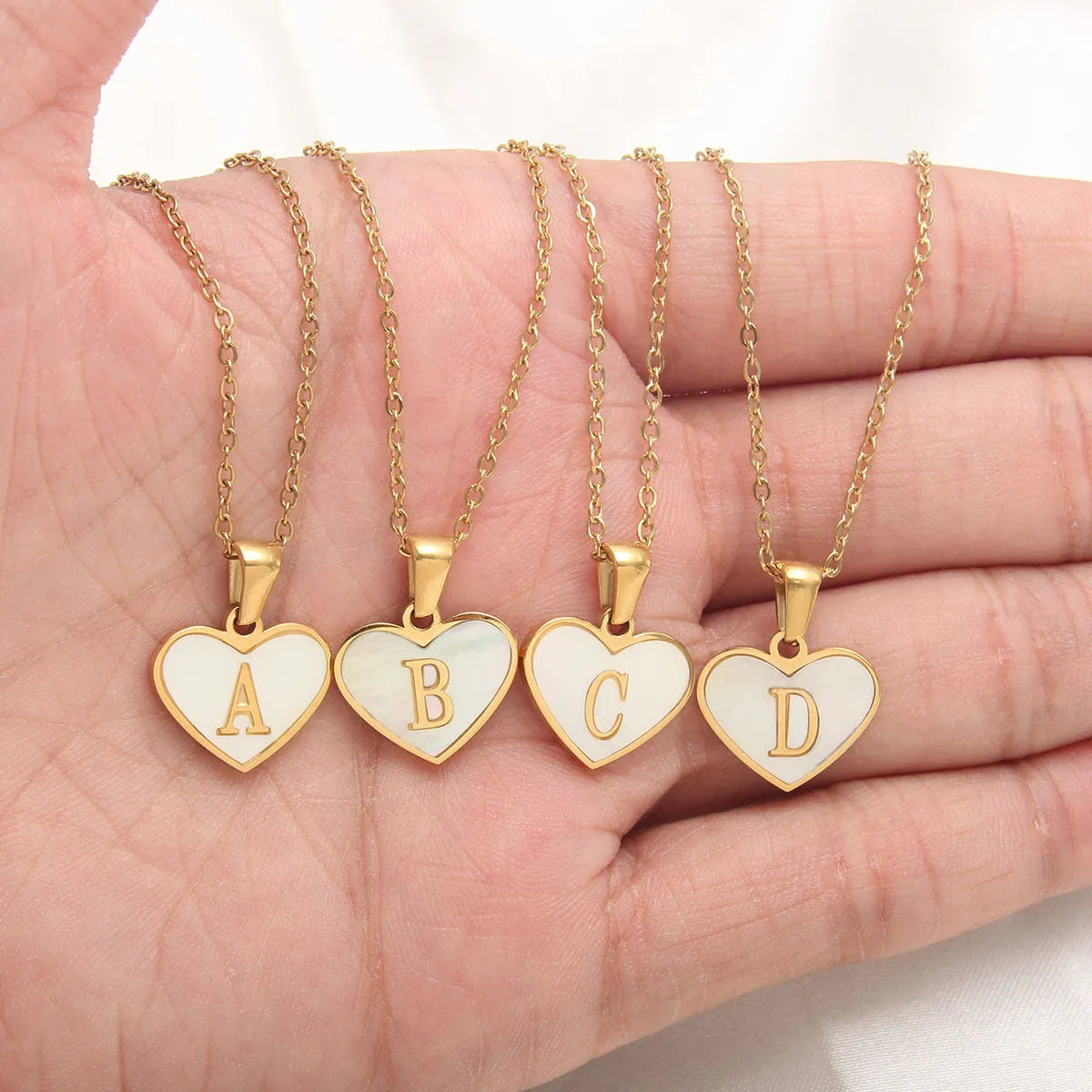 Personalised white shell heart necklace with gold chain and initial letter engraving