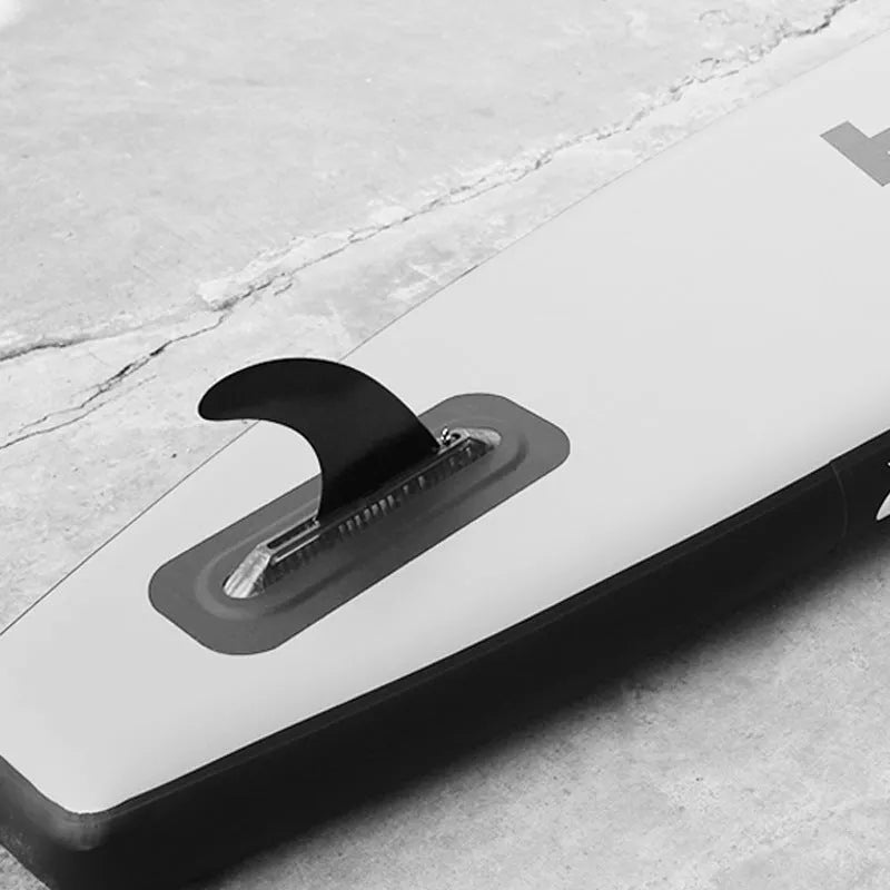 SUP paddle with large removable fish fins showing screw mounting system