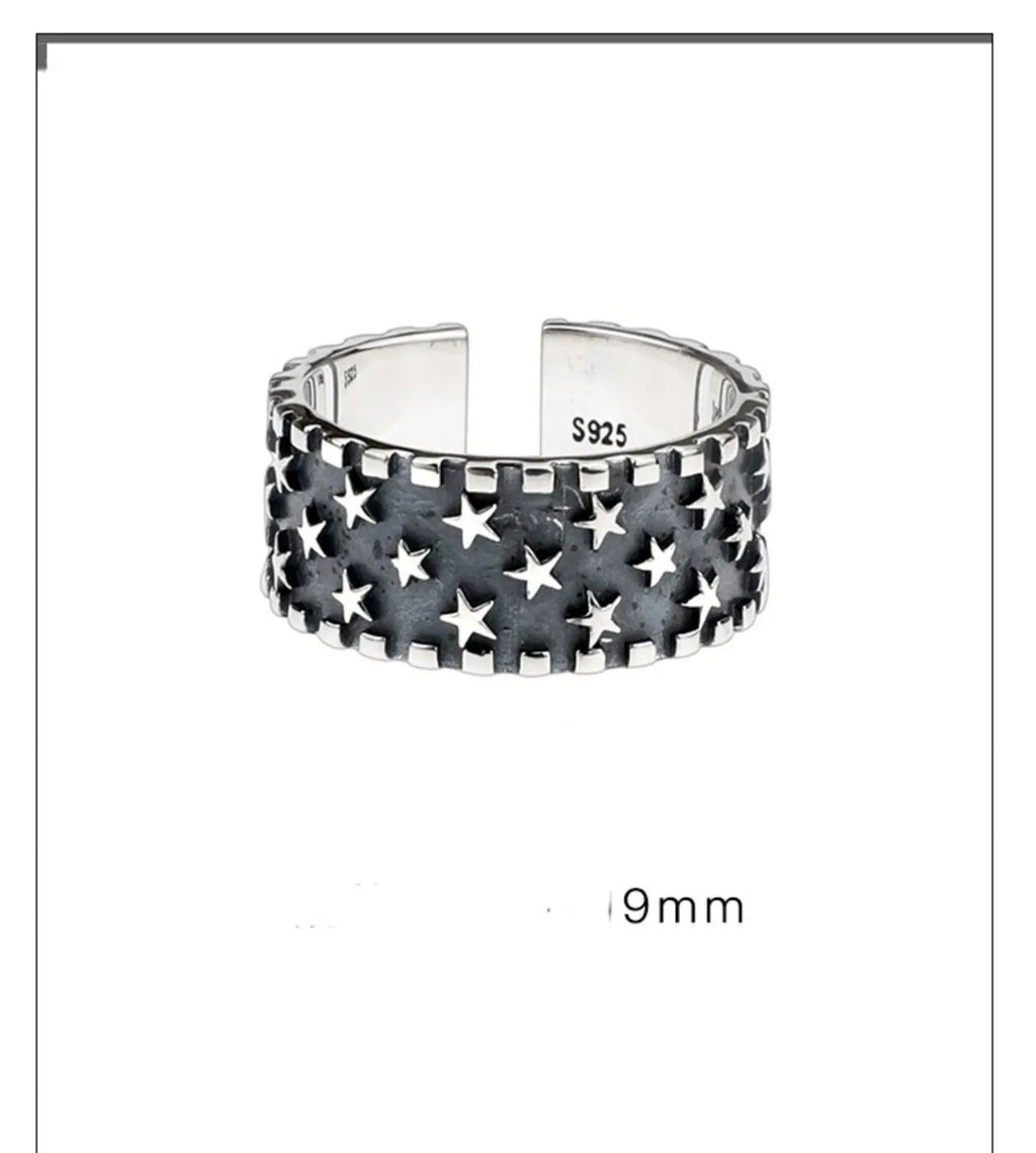 Adjustable silver ring with a multi five-pointed star geometric pattern.
