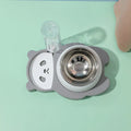 Elevated panda-shaped pet feeding bowl set with tilted stainless steel bowl and automatic water dispenser bottle