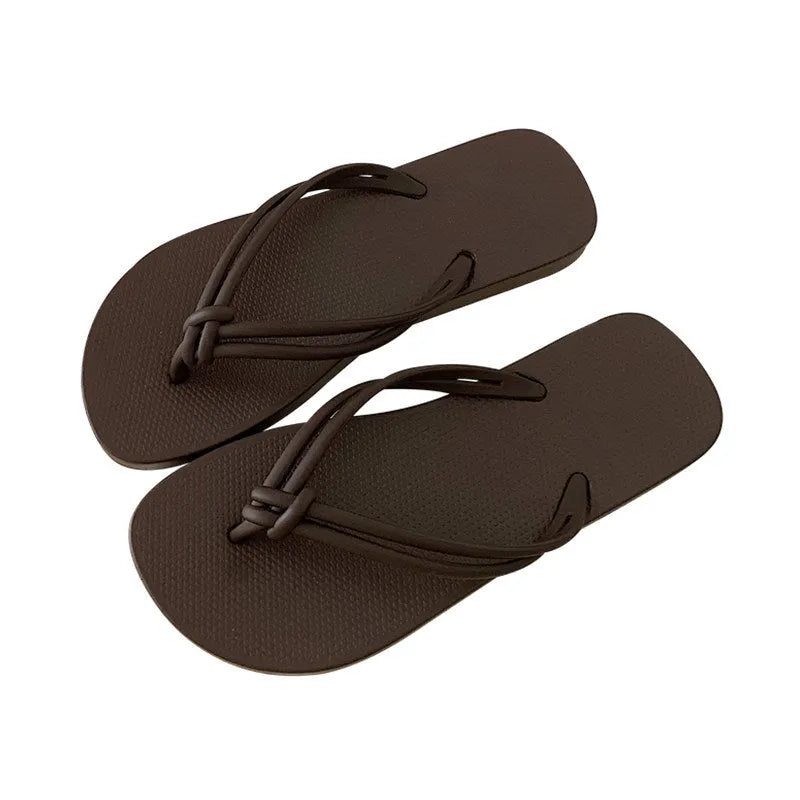 Men's PVC toe-covering flip flops on a solid colour background, showing the non-slip sole and range of available colours.