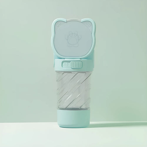 Green 3-in-1 portable pet water bottle with integrated food container and waste bag dispenser on a strap.
