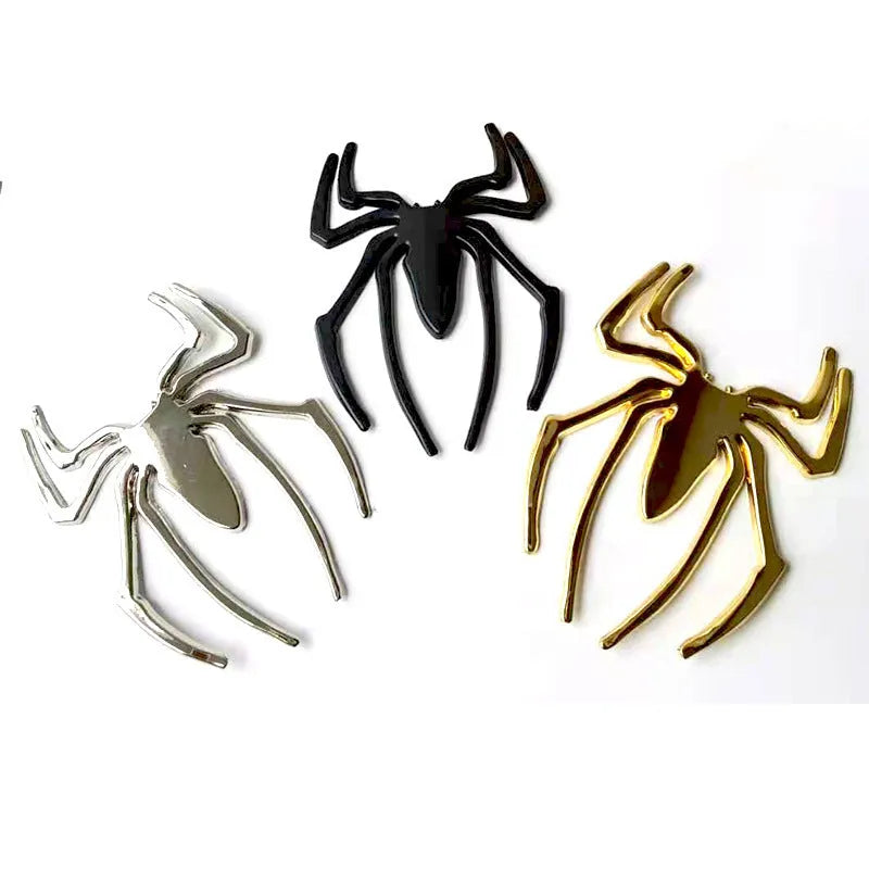 Three-dimensional metal spider bumper sticker in zinc alloy, showing gold colour option.