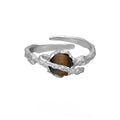 Women's adjustable Saturn design ring in silver with white gold electroplating.