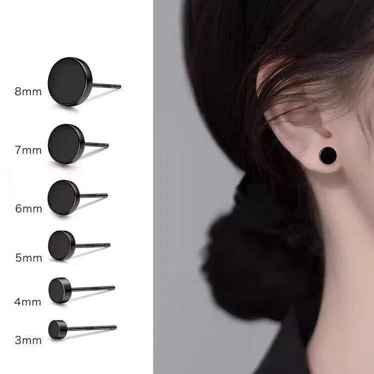 A pair of flat, round S999 sterling silver ear studs on a plain background, shown in silver and black colour options.