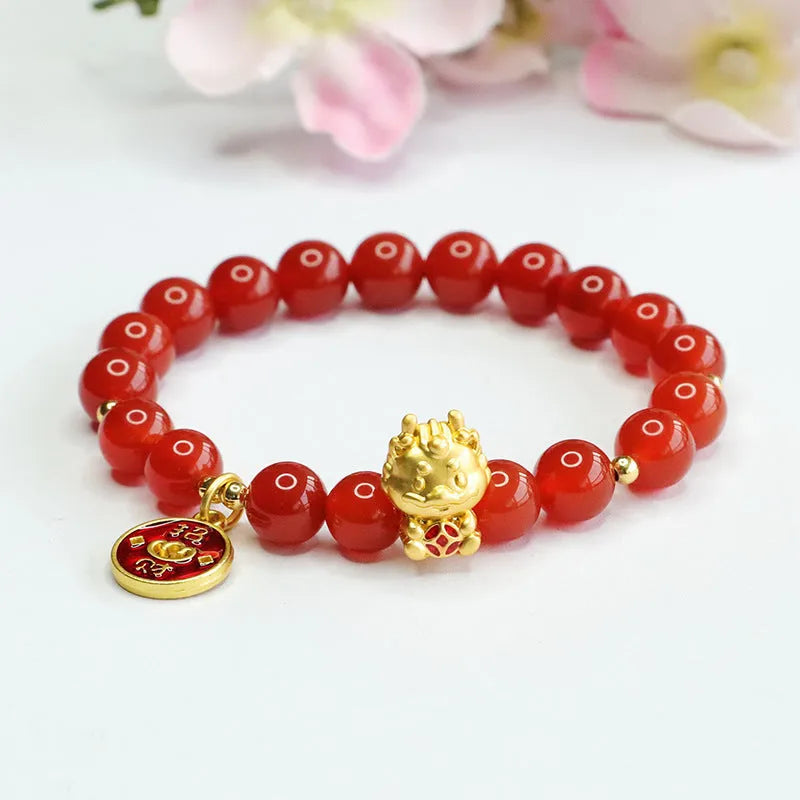 Close-up of a Chinese zodiac dragon bracelet with 8mm red agate beads on a wrist.