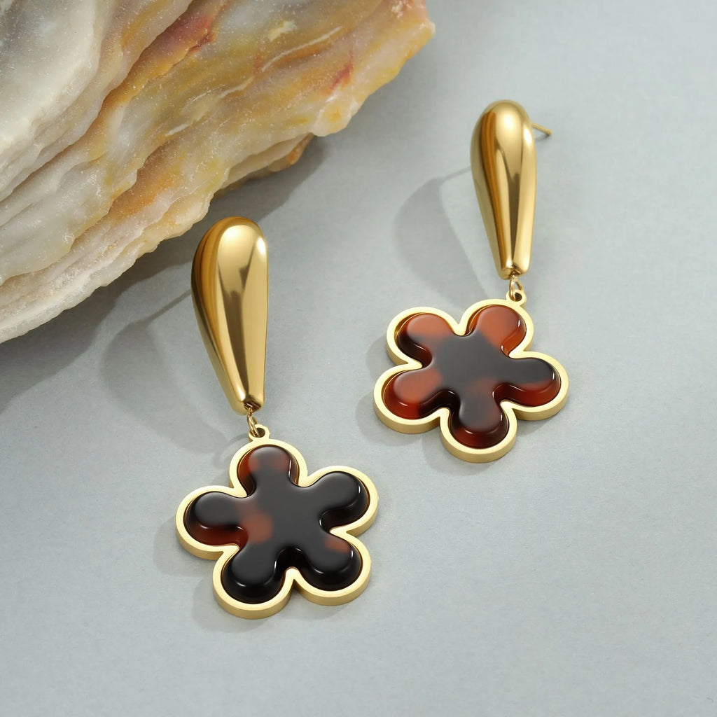 Gold electroplated tortoiseshell resin earrings in heart and flower designs on stainless steel