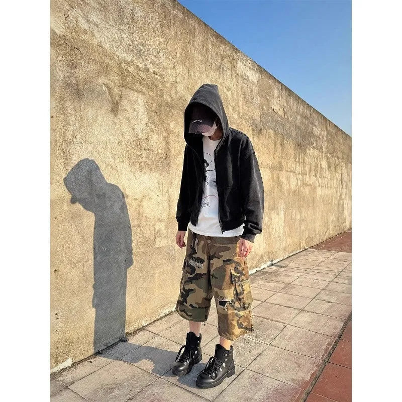 Men's loose camouflage cropped jeans with ripped knees and retro patch detailing on a thin cotton fabric.