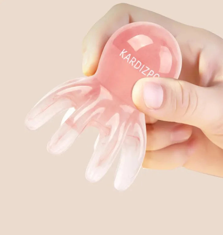 Pink octopus-shaped massage comb for periocular meridian acupressure with curved arms and storage bag