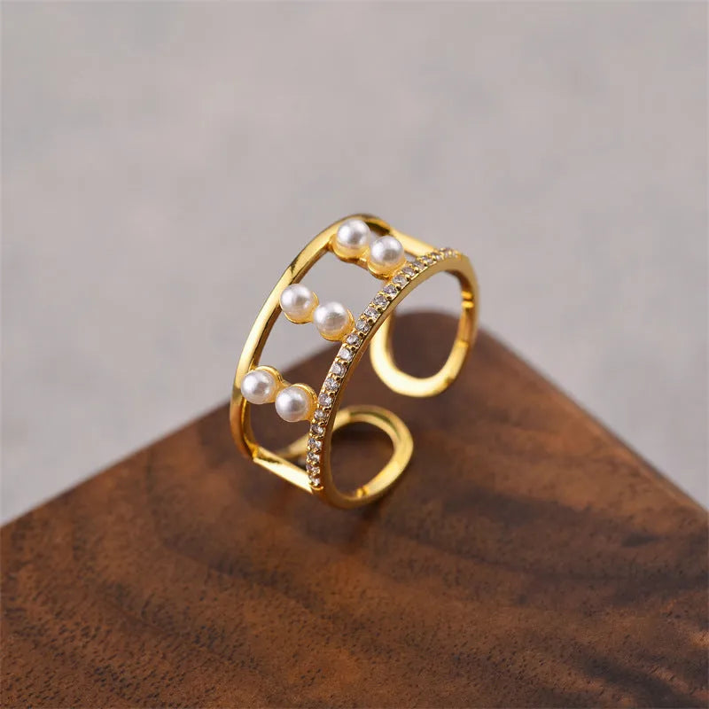Gold geometric open ring for women on a plain background, showcasing its Korean fashion-inspired design.
