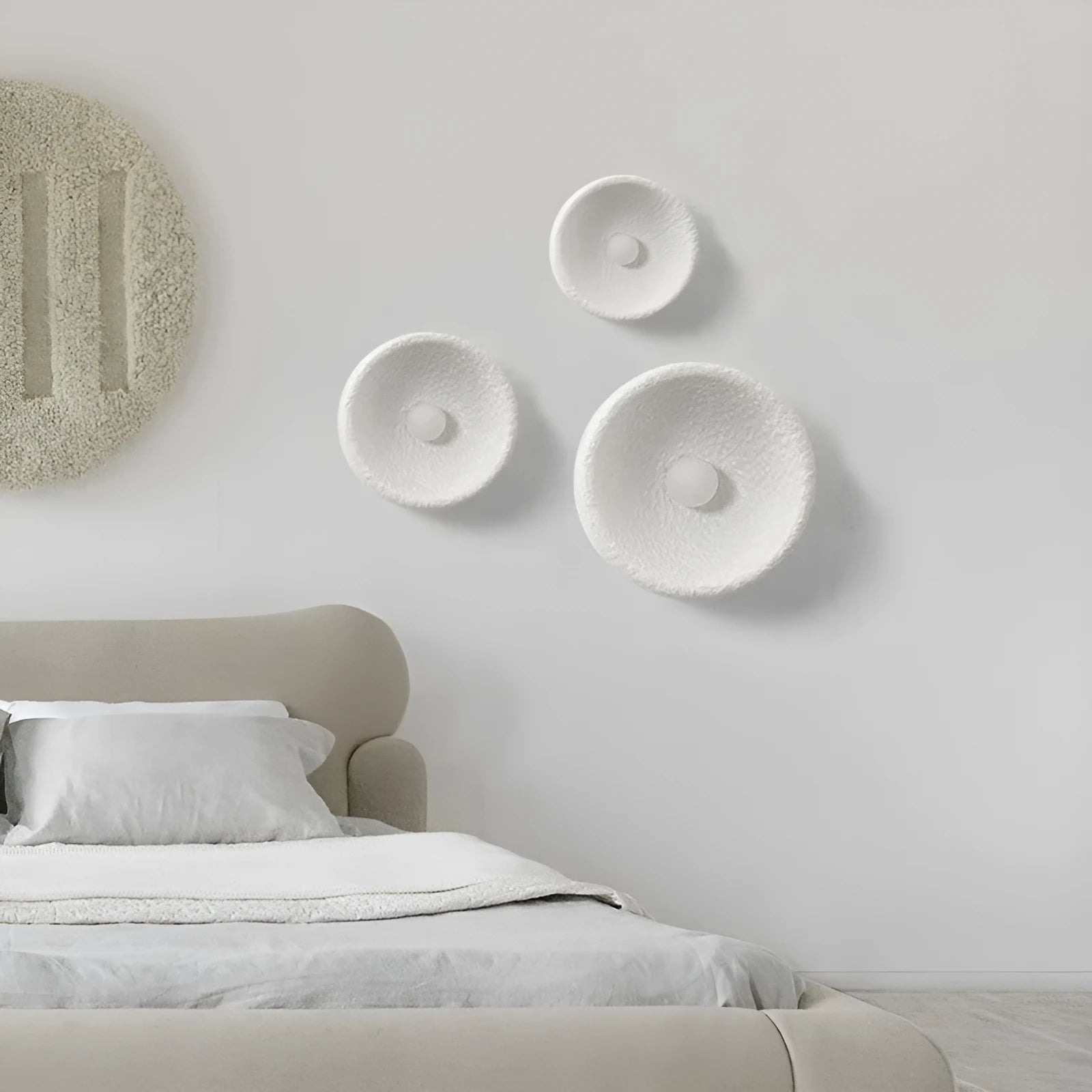 Japanese-style simple silent wall lamp with white resin shade in a modern room setting.