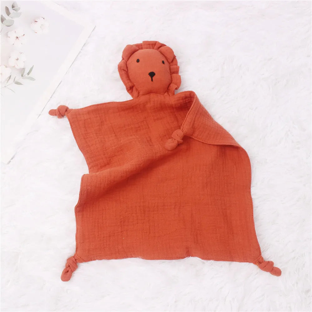 Baby muslin cotton gauze comfort towel 30x30cm in brick red, used as a sleeping towel for infant with lion design