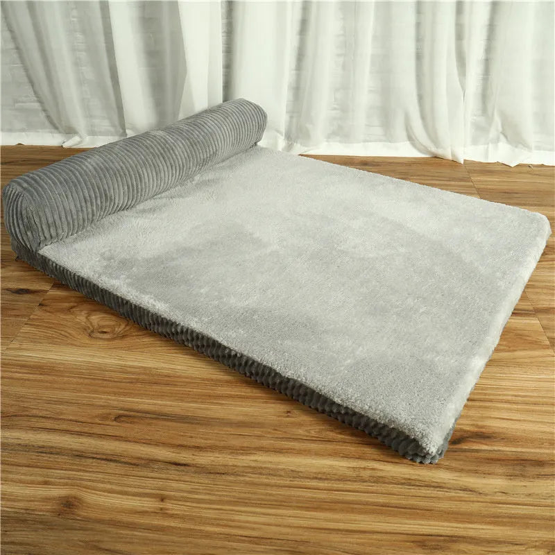 Corduroy pet dog sofa bed in grey colour with a bilateral bolster, shown on a wooden floor.