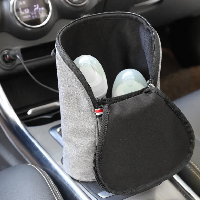Grey Oxford cloth portable baby bottle warmer with carry handle and electronic display for car travel.