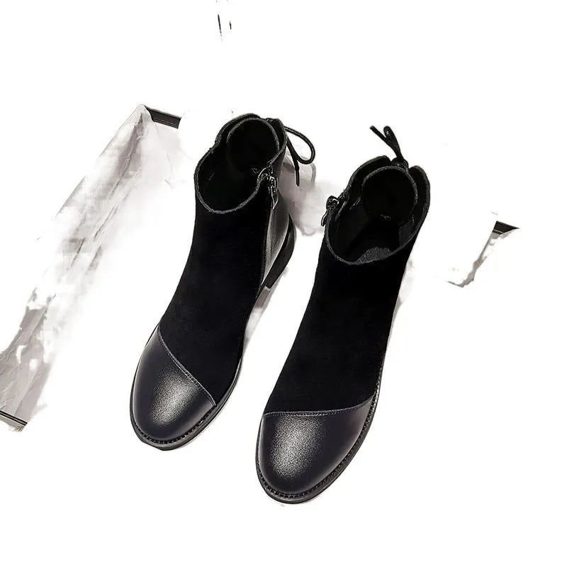 Black women's side-zip Martin boots with a round toe and short heel on a non-slip sole.