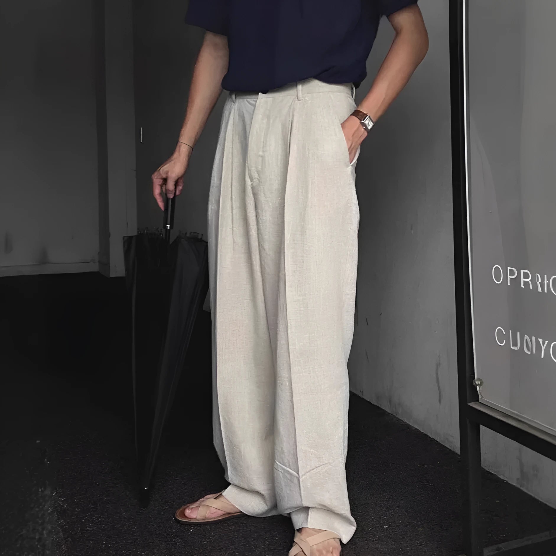 Men's light-weight wide-leg cotton linen trousers in apricot colour, showing loose fit and zip placket.
