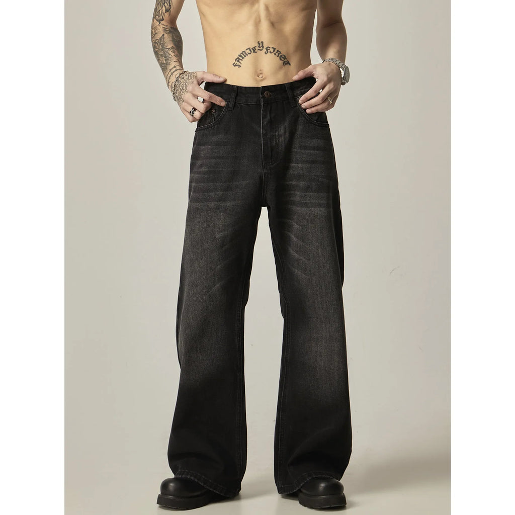 Black loose-fit straight leg denim jeans on a mannequin, showing the zip fly and retro style.