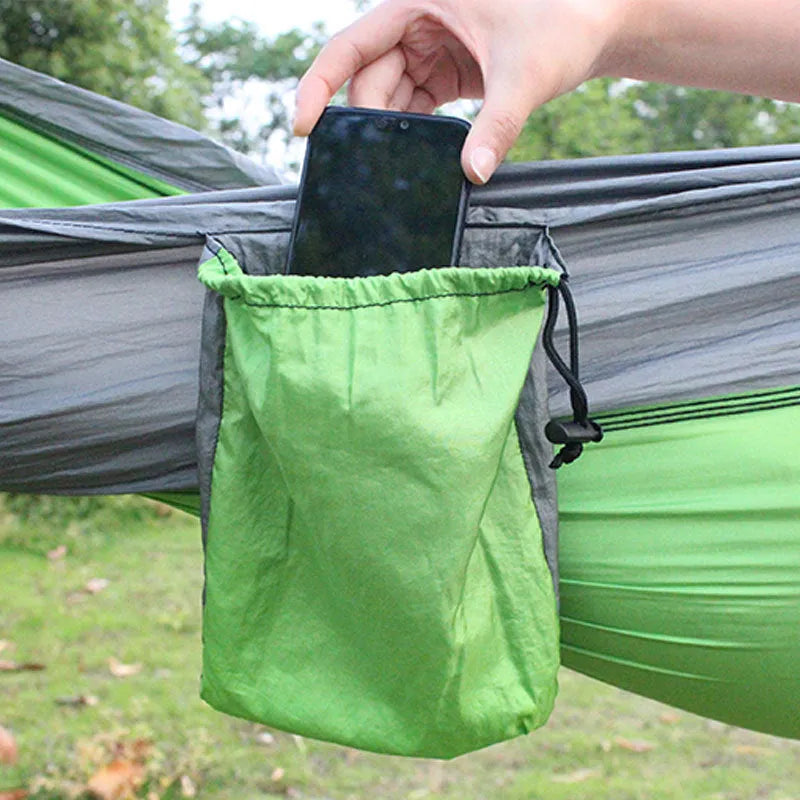 Blue parachute cloth camping hammock hung between trees showing 270cm length