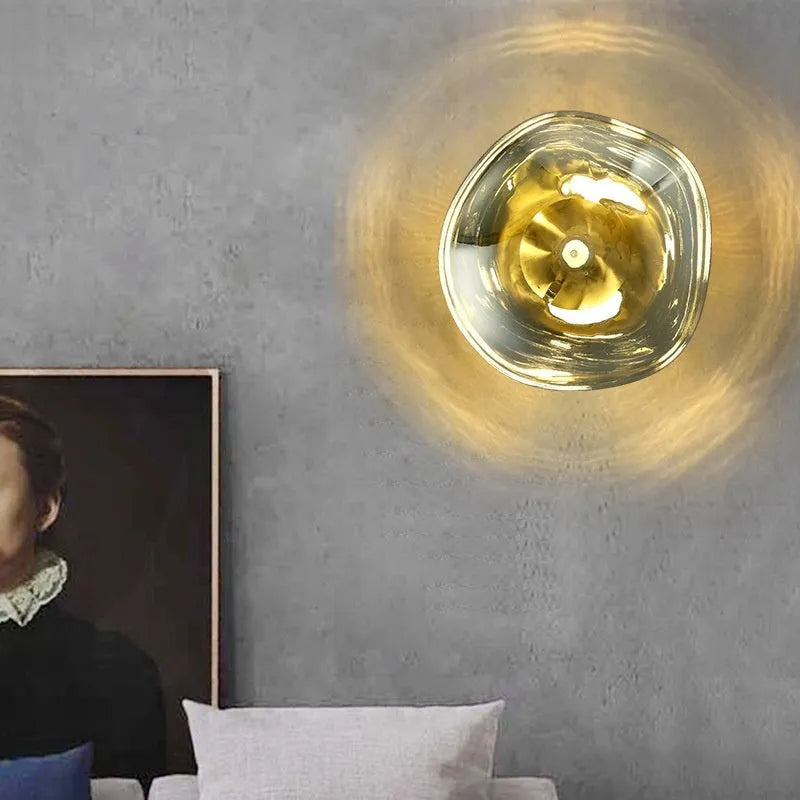 Modern creative lava wall lamp with acrylic shade, 30x18cm, gold finish, on a wall emitting warm light