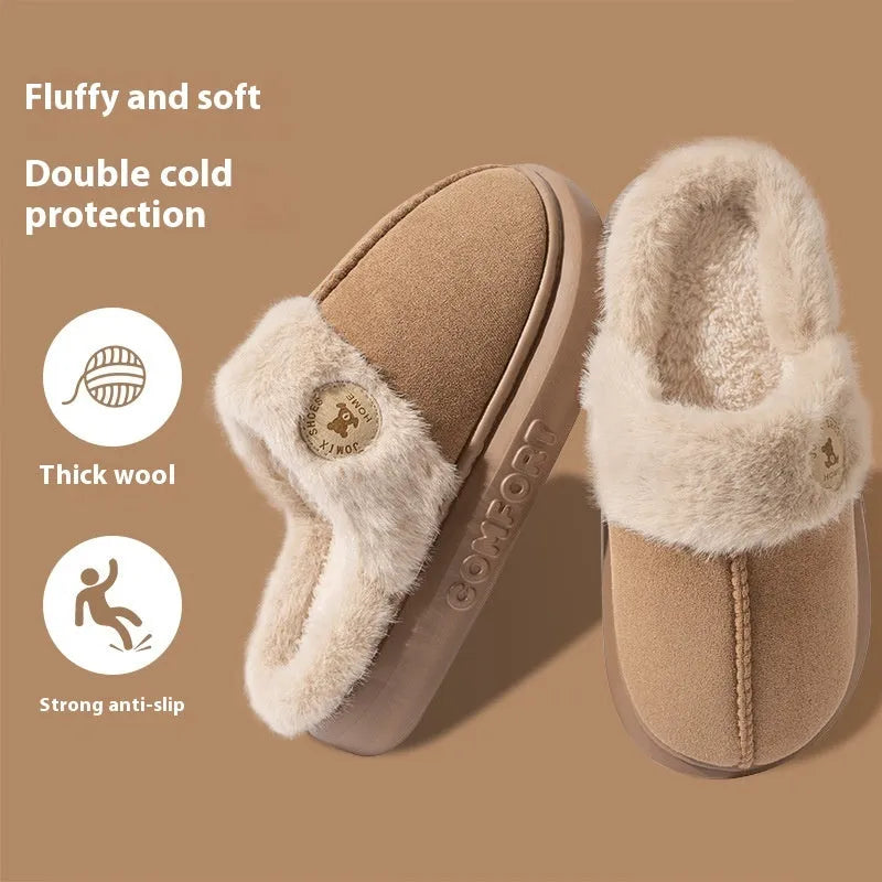 Pair of plush fleece slippers with textured PVC sole and cross stitching detail.