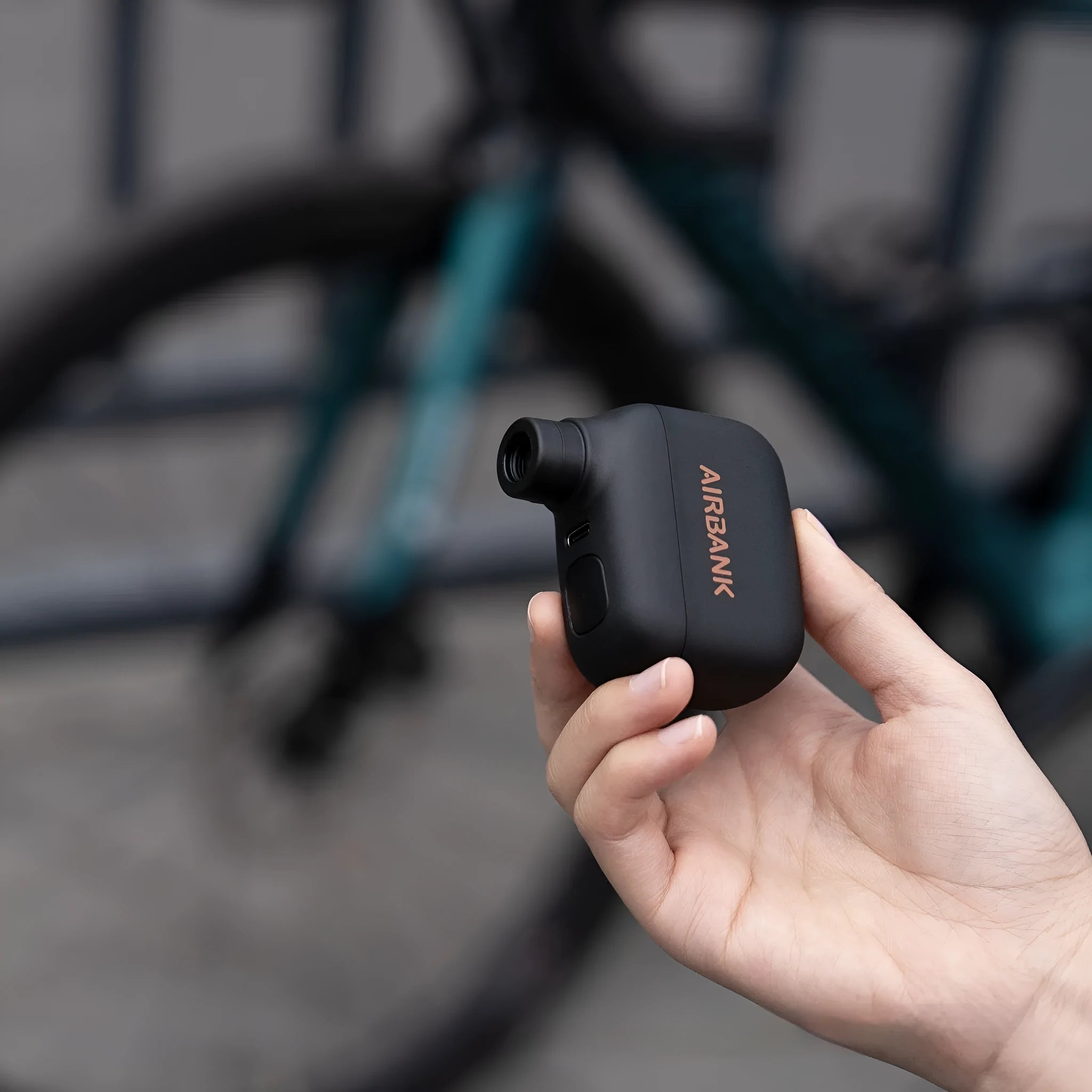 Black AS100 mini electric bicycle pump with USB charging cable and waterproof bag