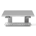 Black aluminium alloy laptop stand on a desk, showing its wide base plate and elevated height.