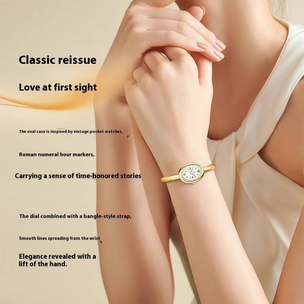 Women's retro oval quartz watch in gold colour with spiral pattern design on wrist
