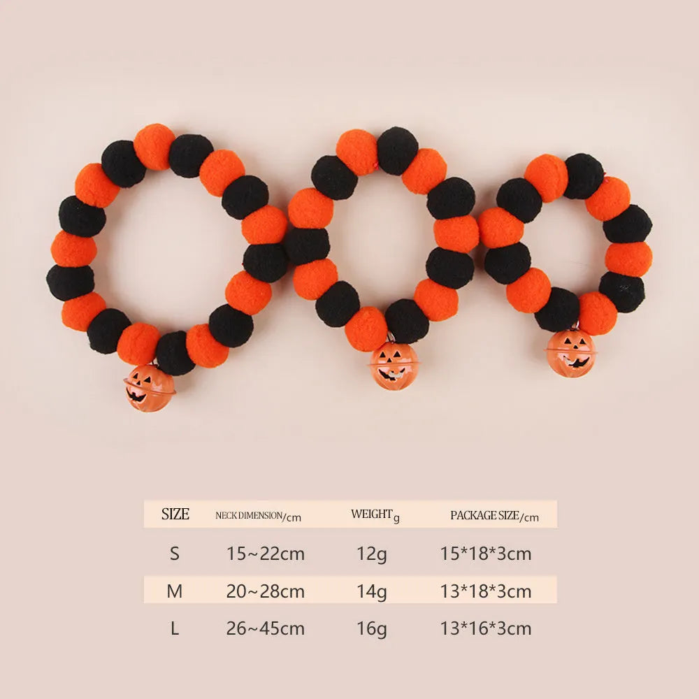 Halloween pet collar with orange pumpkin charm on black and white patterned nylon strap.